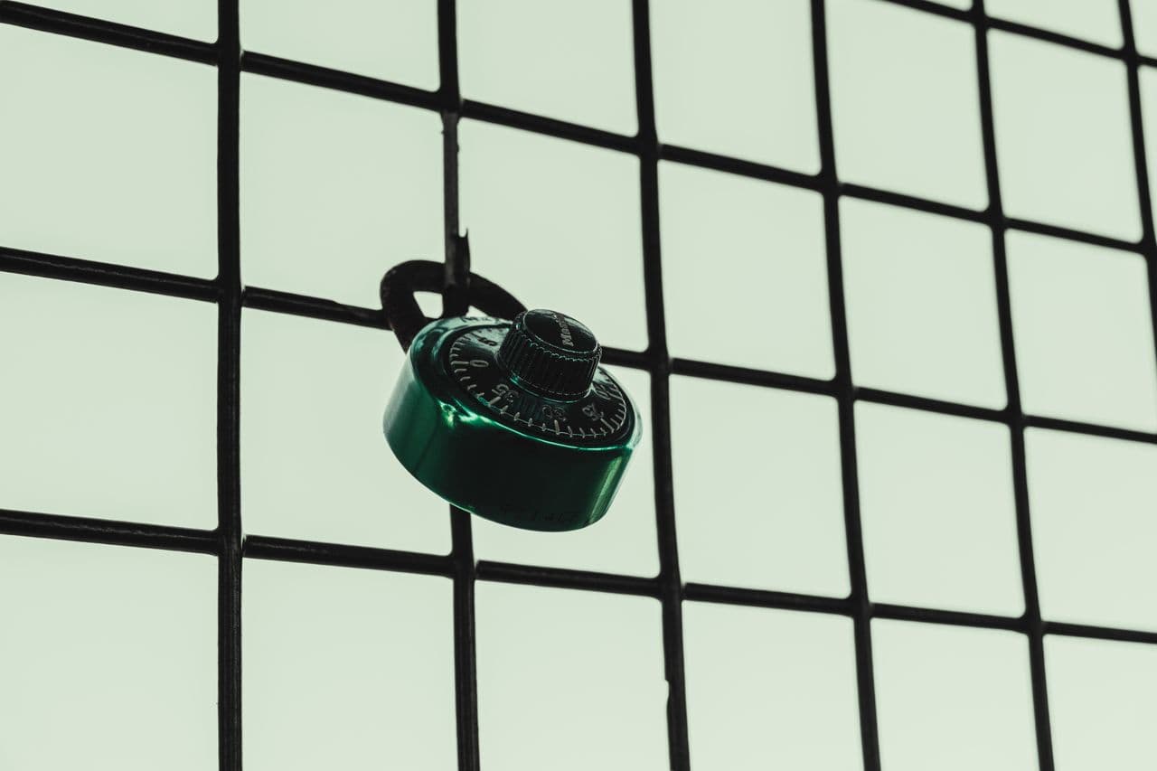 Combination padlock on wire mesh — symbol of security and protection