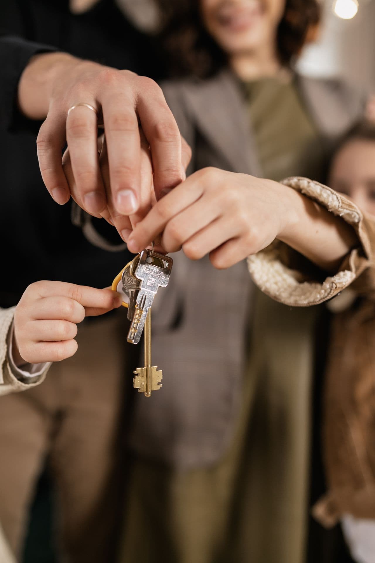 Family holding house keys — protecting what matters most